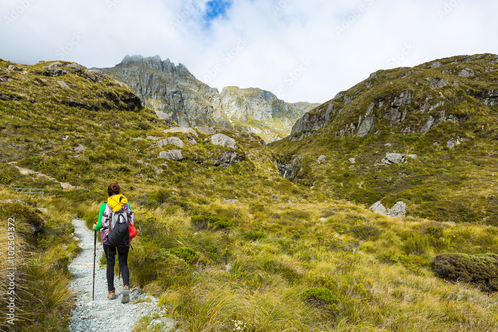 woman hiker with backpack hiking on Routeburn Track