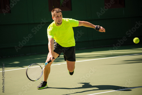 Man plays tennis in bright cloth © fesenko
