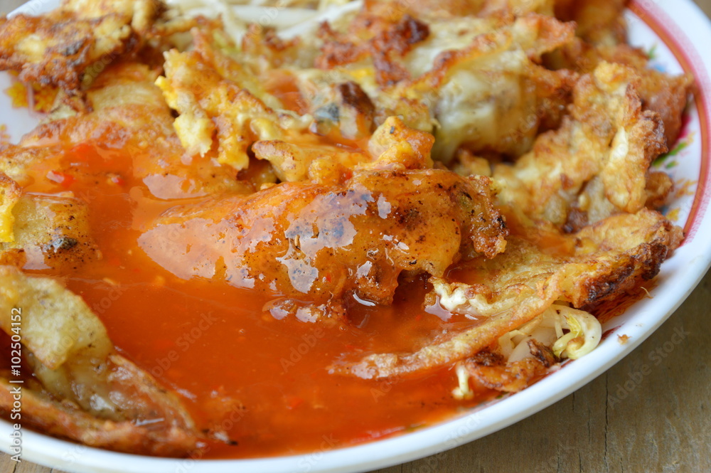 fried mussel omelet dressing chili sauce on dish fried mussel omelet dressing chili sauce on dish
