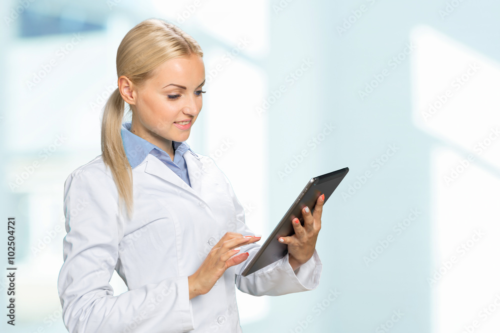 Beautiful smiling doctor woman in medical gown Beautiful smiling doctor woman in medical gown