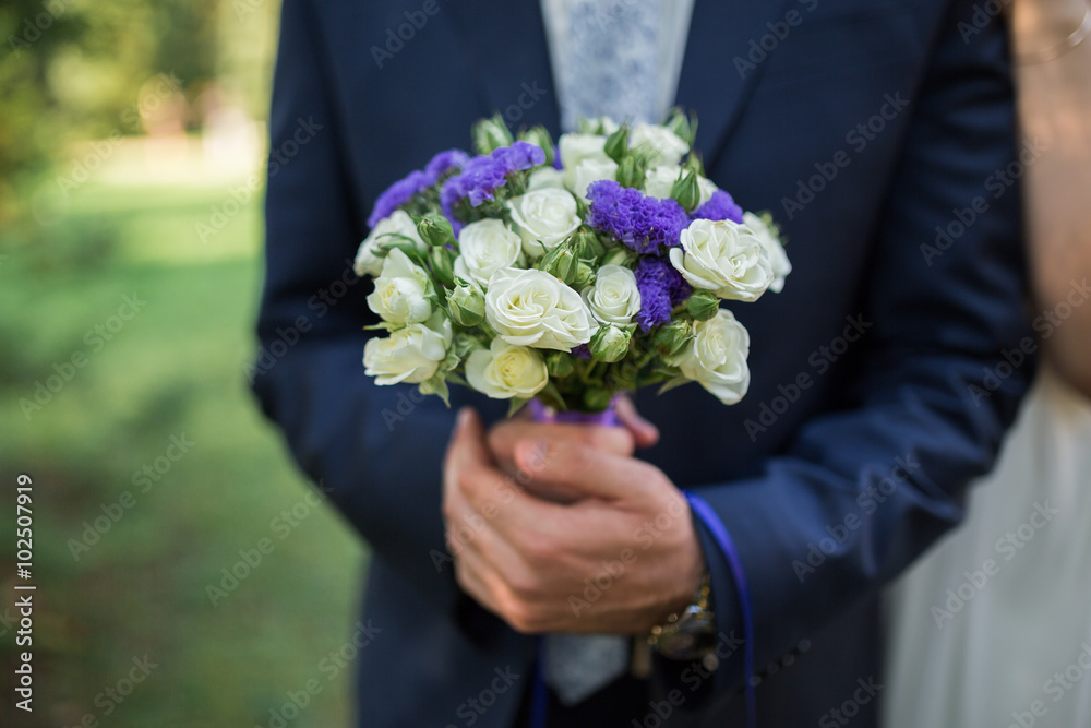 groom hold wedding bouquet in hand groom hold wedding bouquet in hand