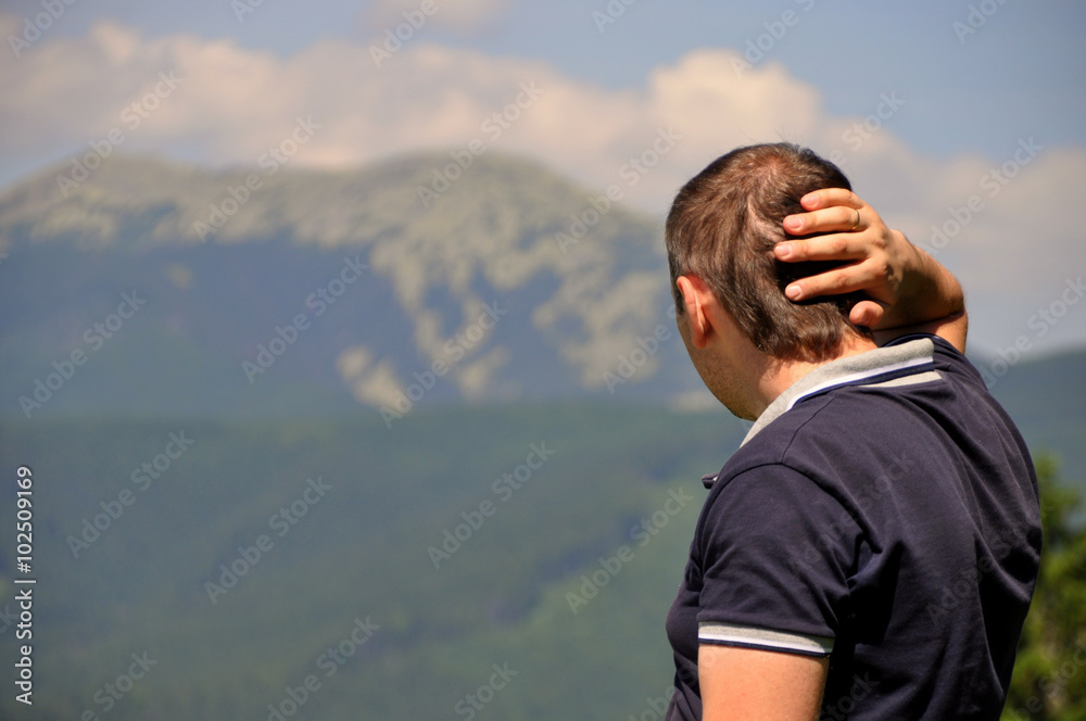 Male hiker looking at a beautiful mountain landscape Male hiker looking at a beautiful mountain landscape