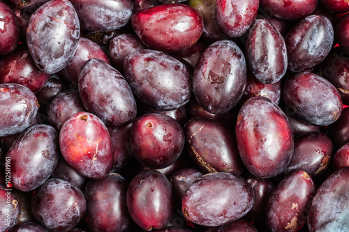 Prune plums background texture.