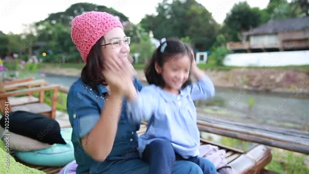 Mother and daughter enjoy and relaxing beside river Mother and daughter enjoy and relaxing beside river