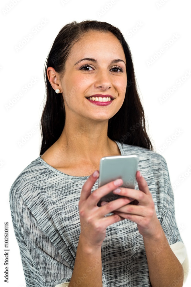 Smiling woman using smartphone and looking at the camera Smiling woman using smartphone and looking at the camera