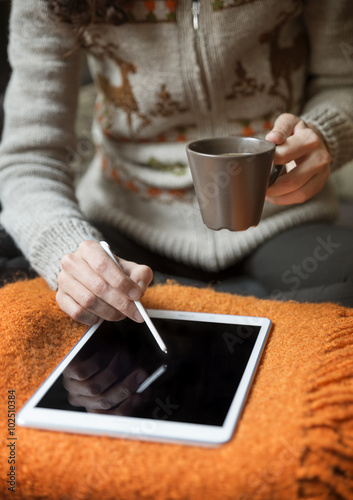 Woman Using Digital Tablet And Drinking Coffee At Home  photo