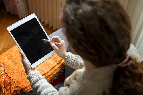 Woman Using Digital Tablet With Touch Pen photo