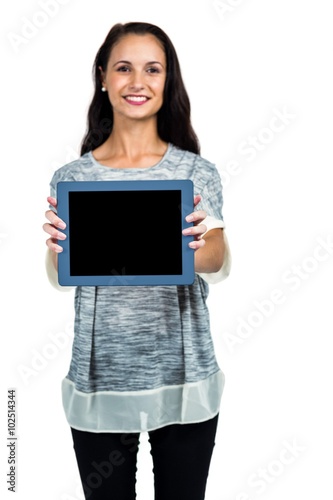 Smiling woman showing tablet screen at camera photo