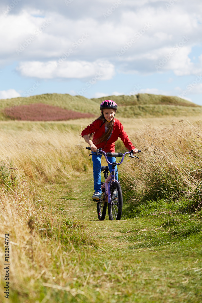 Girl Riding Bike Through Countryside