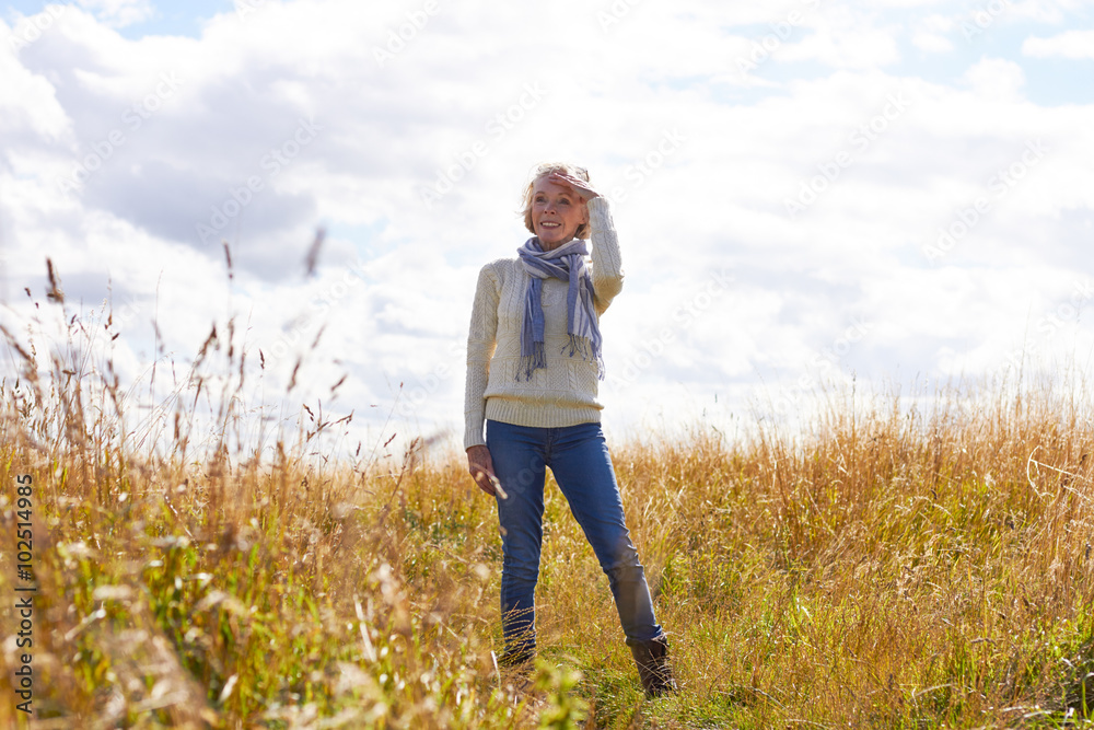 Senior Woman On Walk In Countryside