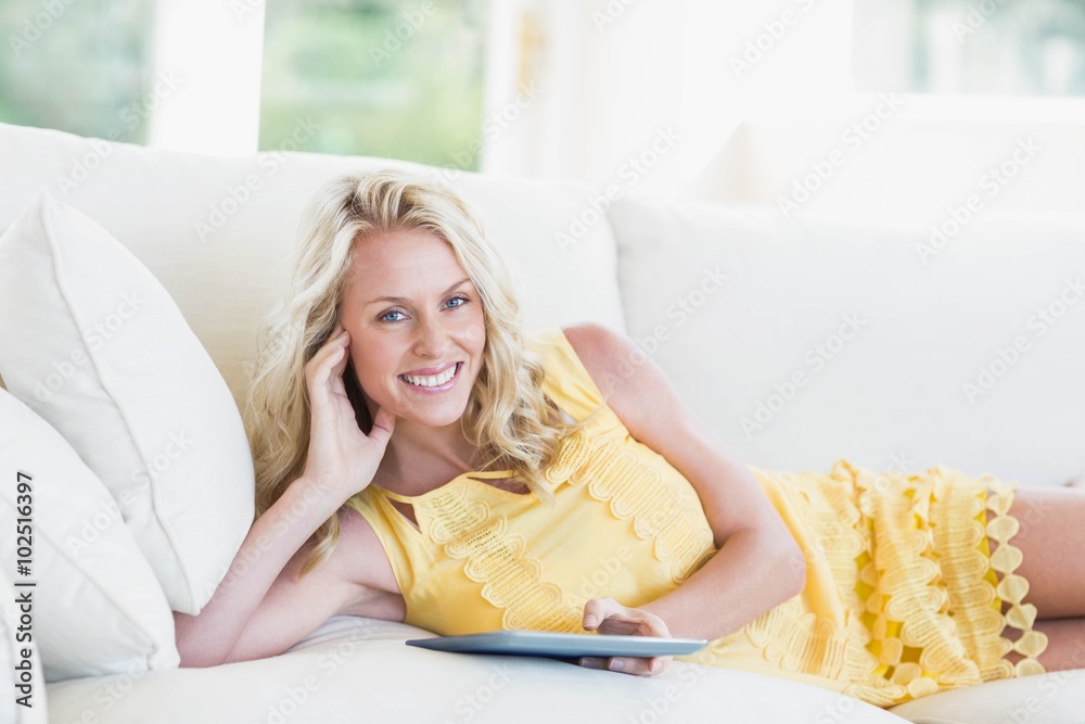 Happy woman using tablet on sofa Happy woman using tablet on sofa