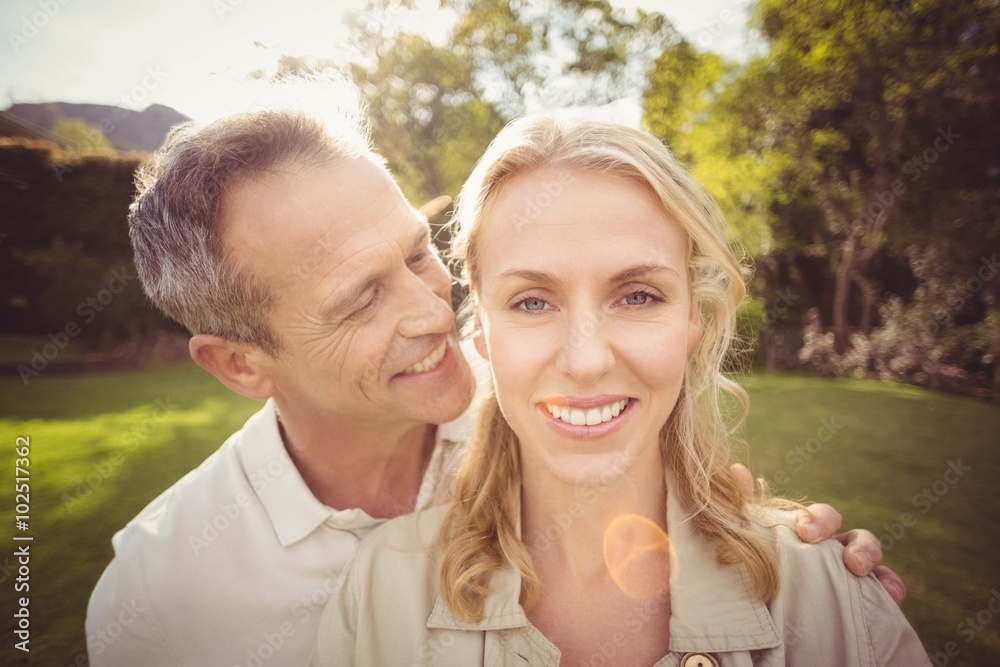 Husband whispering something to wifes ears Husband whispering something to wifes ears