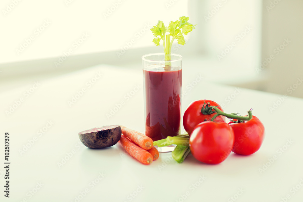 close up of fresh juice and vegetables on table close up of fresh juice and vegetables on table