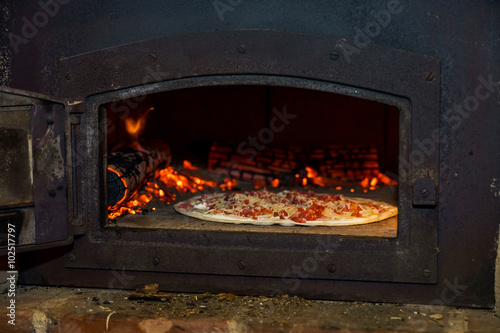 Pizza cooking in natural vintage stove
