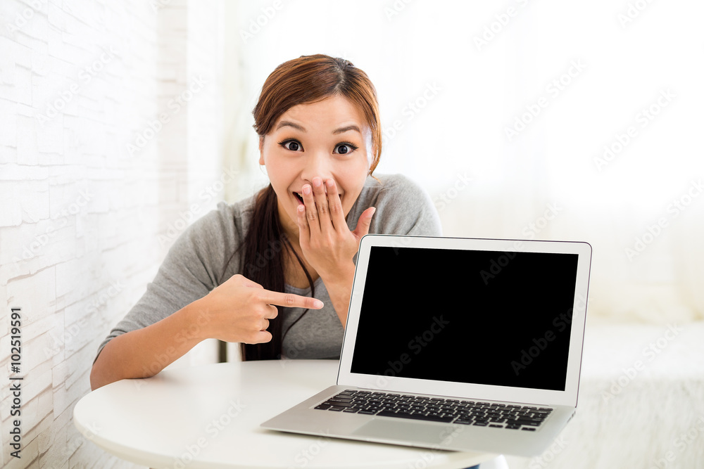 Excited young woman showing laptop computer Excited young woman showing laptop computer