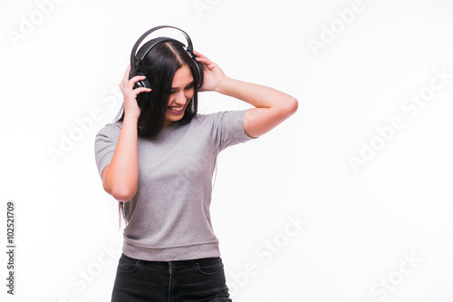 loseup of happy brunet caucasian girl listen dancing to music with headphones on a white background
