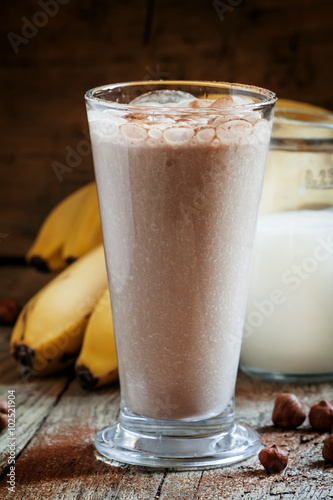 Fresh smoothie banana and chocolate, milk and nuts in a large gl