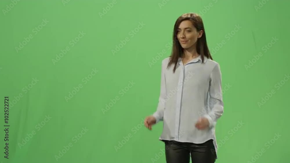 Woman is pushing a virtual interactive interface on a mock-up green screen in the background. Shot on RED Cinema Camera. Woman is pushing a virtual interactive interface on a mock-up green screen in the background. Shot on RED Cinema Camera.