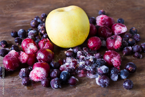 Frozen cherries aplle and black currant  on ice