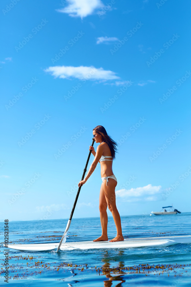 Summer Water Sports. Happy Fit Woman With Sexy Body Paddling, Standing Up On Paddle, Surf Board In Ocean. Holidays Travel Vacation. Healthy Active Lifestyle. Recreational Leisure Activity, Wellness.