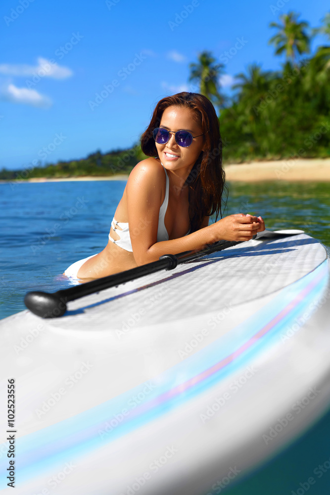 Summer Holidays. Close Up Of Happy Smiling Young Woman In Bikini On Surfing, Surf Board In Sea. Travel Vacation To Exotic Resort. Fun And Happiness. Healthy Lifestyle. Water Sports. Beauty, Recreation