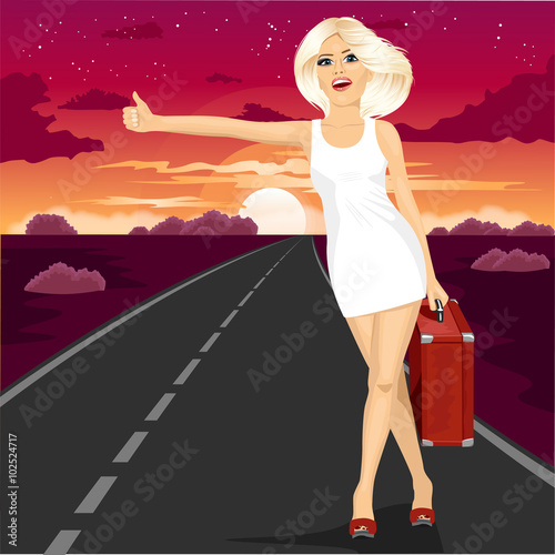 attractive blonde standing with suitcase voting on road