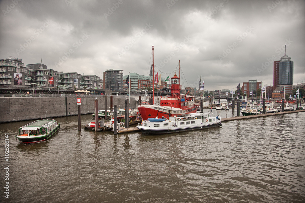 Downtown Hamburg on a cloudy day. Boats passing on the waterways.