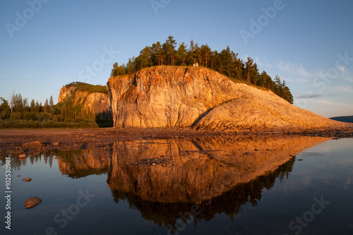 The rocky shore of the river, in the light of the setting sun. Lena river. Yakutia. Russia. photo