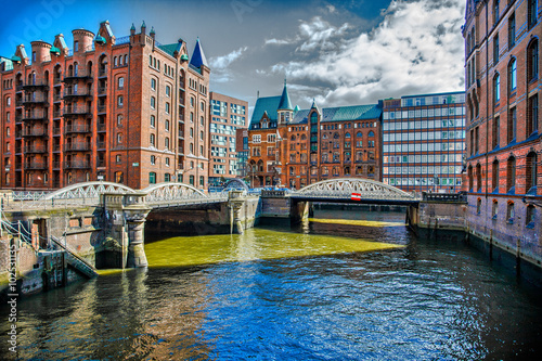 Downtown Hamburg on a cloudy day. Tourist boats passing on the waterways.