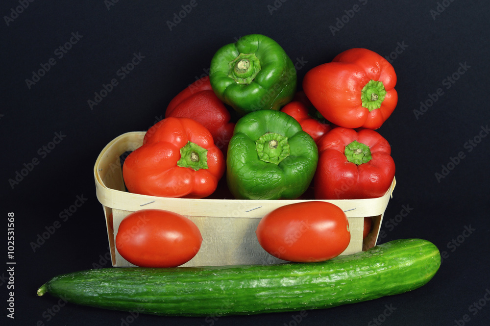 A pepper assortment with tomato and cucumber.