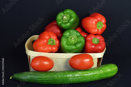 A pepper assortment with tomato and cucumber.