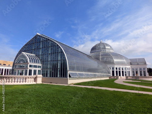 Beautiful botanical garden greenhouse with manicured lawn - landscape color photo