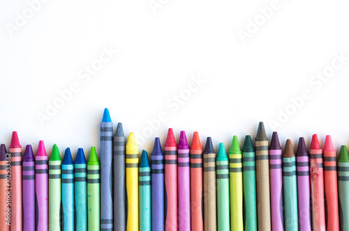 Crayons and pastels lined up isolated on white background