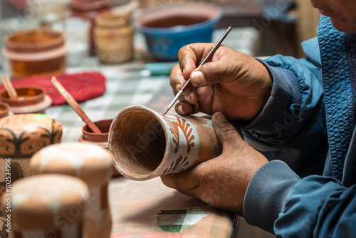 Peruvian Artisan painting a typical peruvian vase photo