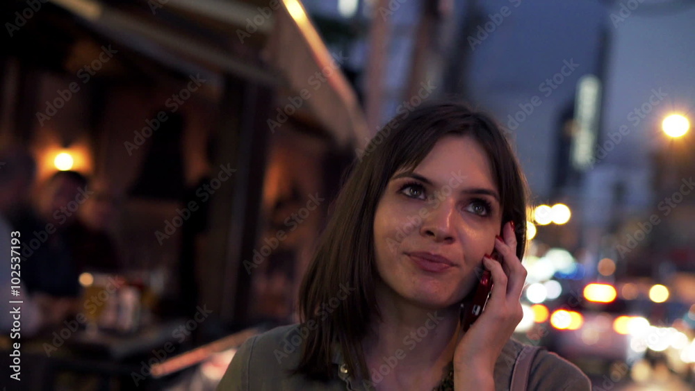 Young woman talking on cellphone by the city street
Young woman talking on cellphone by the city street