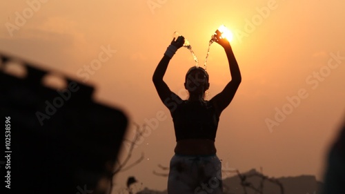 Woman jogging on pathway at sunrise photo