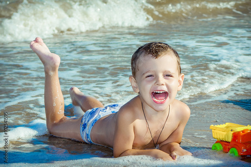 Happy  little boy having fun on the beach