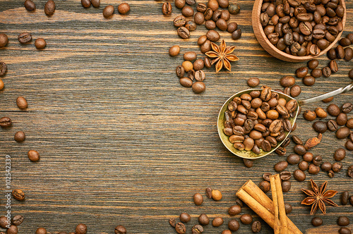 Coffee beans background with spoon. Roasted coffee in the spoon. Top view. Selective focus. Place for text