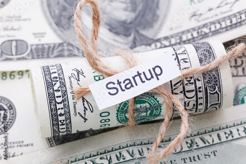 Money and business idea, The dollar bills tied with a rope, with a sign - Startup