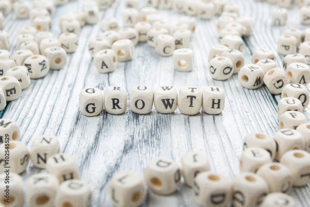 text of Growth on cubes. Wooden ABc text of Growth on cubes. Wooden ABc