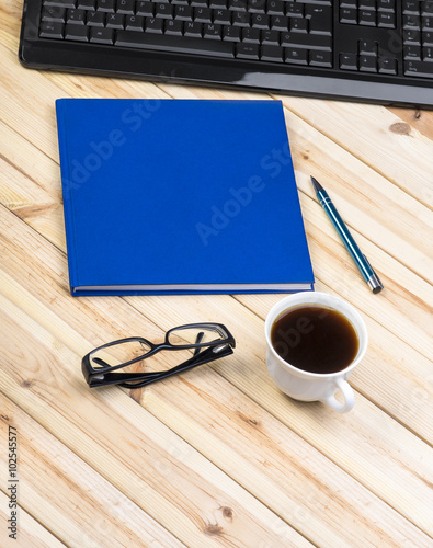 Office Desk With Keyboard  Notepad  Glasses  Pen And Coffee Cup. View From Above With Copy Space.