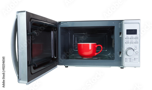 Microwave oven with a red cup. Isolated on white with a clipping