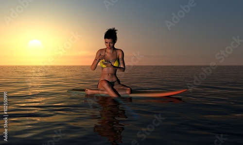 Surfer Girl Texting At Sunrise On Surf Board