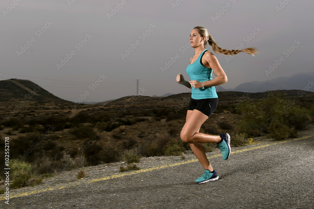 Fototapeta premium young fit sport woman running outdoors on asphalt road in mountain fitness workout