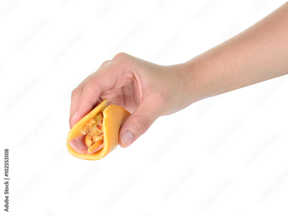 female hand holding rolled pancakes stuffed ham and cheese. female hand holding rolled pancakes stuffed ham and cheese.