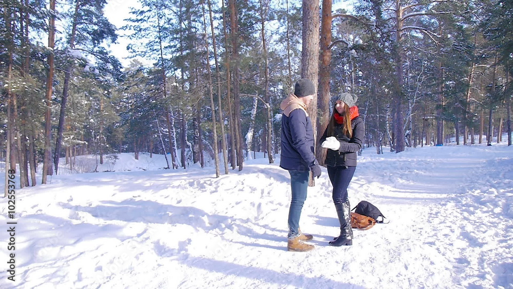 Young and beautiful couple in love walking in the winter woods Young and beautiful couple in love walking in the winter woods