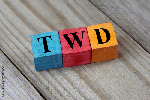 TWD (Taiwan New Dollar) symbol on colorful wooden cubes photo
