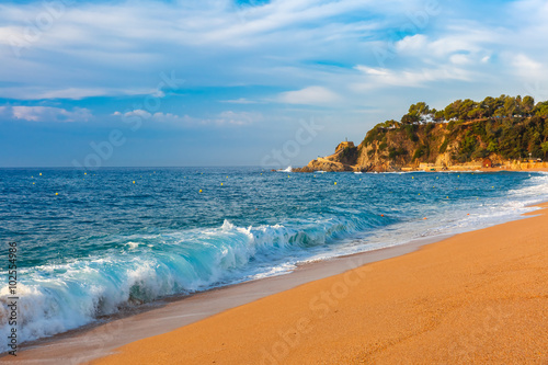 Sea waves and sand main beach at popular holiday resort Lloret de Mar on Costa Brava in the morning   Catalunya  Spain