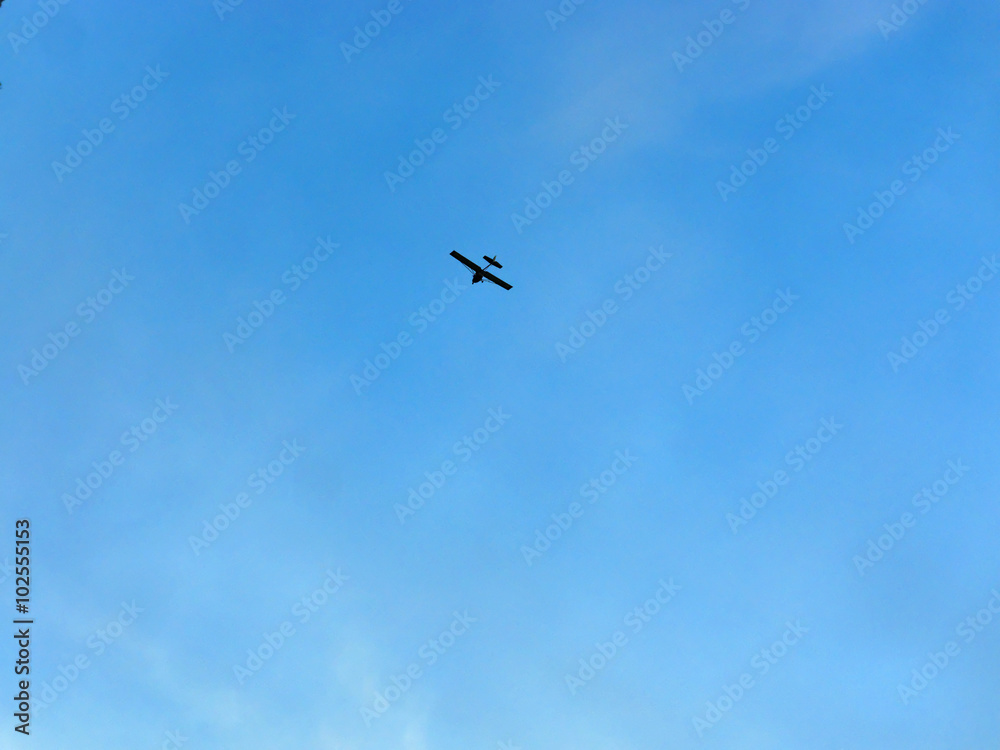 light private airplane against blue sky light private airplane against blue sky