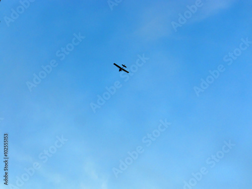 light private airplane against blue sky
